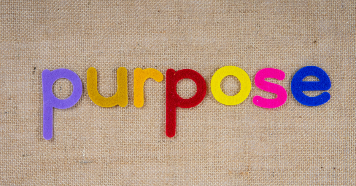 Felt letters spelling the word purpose on an hessian background